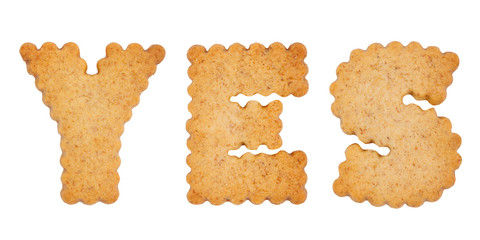Word YES made of sweet cookie alphabet letters isolated on white background. Diet concept. Gluten-free concept
