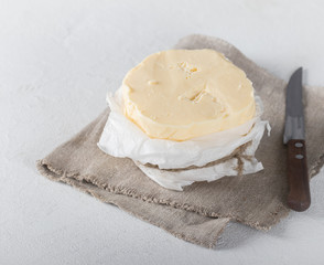 Rustic farm product, butter on a rustic linen napkin on a white background