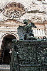 Fototapeta na wymiar Angel holding a shield with Colleoni Coat of Arms as a decoration of the fence of Bergamo cathedral in Italy