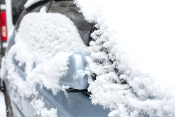 Car covered in snow after a small snowstorm