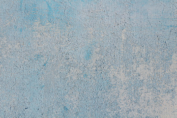 Soft blue abstract background with cracked paint.