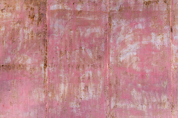 pink background of a painted rusty metal surface