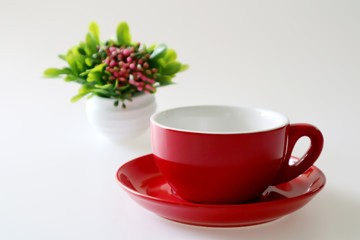 Obraz na płótnie Canvas Red coffee cup and saucer isolated on white background.