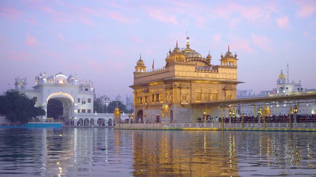 India, Punjab, Amritsar, (Golden Temple), The Harmandir Sahib, Amrit Sagar (lake of Nectar), illuminated at dusk