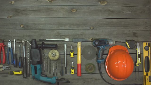 A variety of electro and hand tools. Top view.  On the table are tools for various types of construction and repair work on wood, metal, concrete, plastic and other materials.