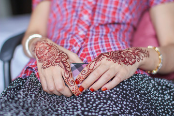 Very beautiful and unique henna paintings are on both hands of the bride.