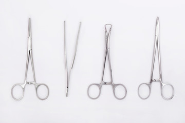 Metal surgical instruments on white background. Flat lay. Top view