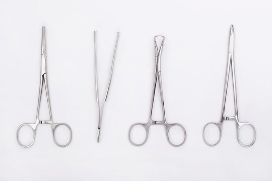 Metal Surgical Instruments On White Background. Flat Lay. Top View