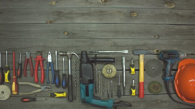 A variety of electro and hand tools. Top view.  On the table are tools for various types of construction and repair work on wood, metal, concrete, plastic and other materials.