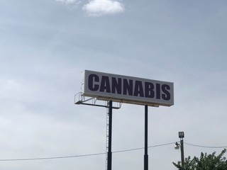 Cannabis directional billboard on the side of a highway