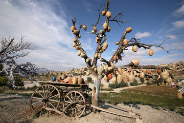 Fototapeta na wymiar Goreme, Turkey - 09/15/2009: A tree decorated with souvenir pottery in the vicinity of the Goreme village in the Cappadocia region of Turkey.