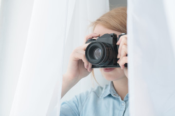 Photographer taking pictures through the white curtain