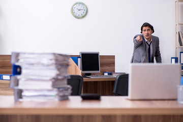 Young male employee unhappy with excessive work