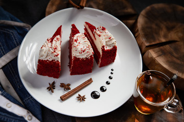 Cake with red topping and cream on a white plate