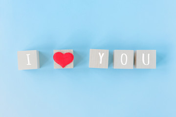 I love you wooden cubes with red heart shape decoration on blue table background and copy space for text. Love, Romantic and Happy Valentines day holiday concept