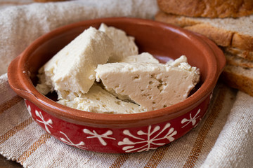 Feta cheese in clay serving dish