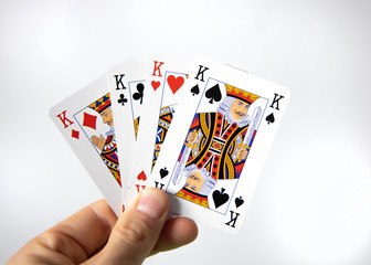 Hand holding a winner cards of poker over a white background