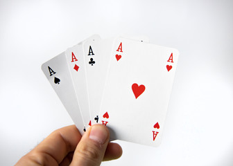 Hand holding a winner cards of poker over a white background