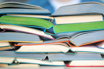 Stack of multicolored open books closeup, education, reading, back to school concept