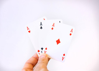 Obraz premium Hand holding a trio of Ace cards of poker over a white background