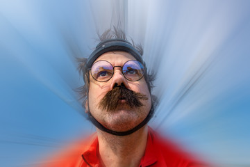 The biker is racing on a road bike, blurred  background. Portrait of cyclist in retro helmet riding...