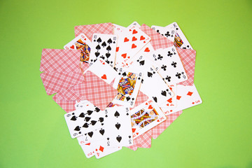 Random Poker cards over a green background