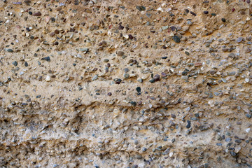 stone and clay wall of an ancient fortress - sandy texture background