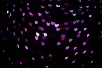 Colorful hearts out of focus. Colorful lights. Dark background. Copy space. Place for text and design.