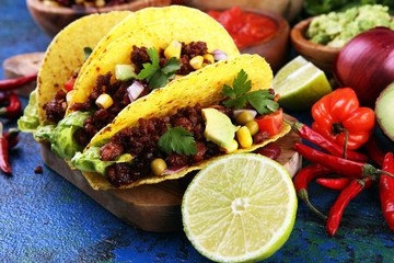 Mexican tacos with beef, tomatoes, avocado, chilli and onions. Handmade tortilla with pork