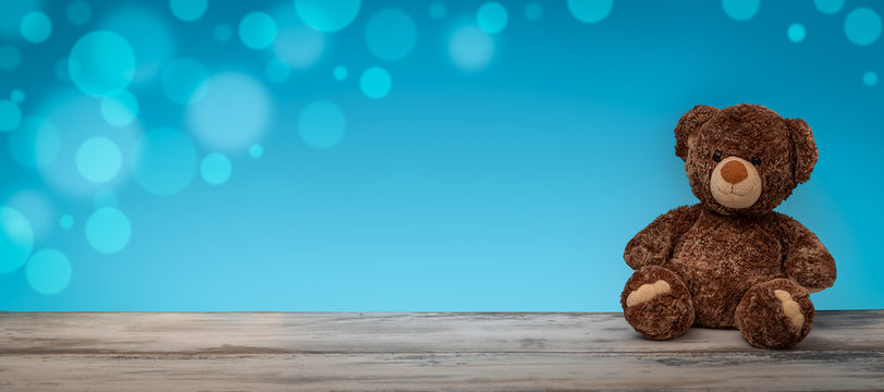 Teddybär mit blauen Hintergrund und Bokeh Effekt als Panorama