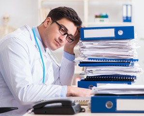 Busy doctor with too much work in hospital