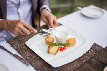 A man is having breakfast at a restaurant.