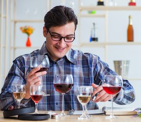Professional sommelier tasting red wine