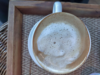 Hot cappuccino coffee in white cup