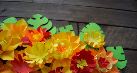 Flowers made of paper. Wooden background.
