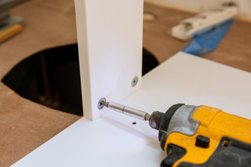 Wooden furniture installing cabinet shelf screws screwdriver handle