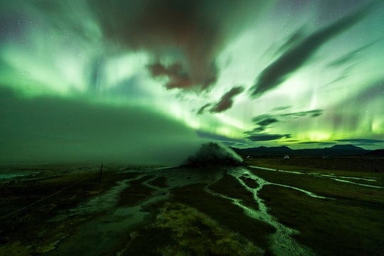 Aurora Borealis (Northern Lights) above geothermal volcanic vents in Hveravellir - Powered by Adobe