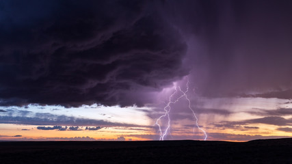 Thunderstorm lightning strike at sunset