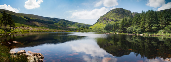 Scenic lake and mountains reflection of glentanassig woods in the Dingle Peninsula, County Kerry, Ireland