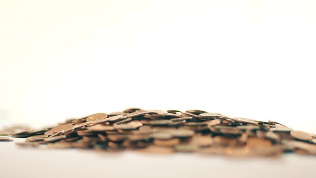 White-gloved hands scooping up a pile of gold coins. They sort out and scatter money.On white background. Garland. Money glitters.