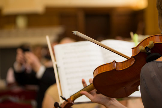 Violinist playing at a wedding orchestra in church
