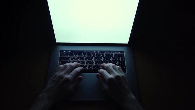 Closeup man sitting table notebook. Hands keyboarding laptop using texting pointing networking white screen. Neon glow, top view. closes and opens the computer.