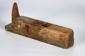 Very old wood working plane on white background