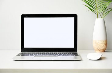 Fototapeta premium Laptop computer with blank screen in office