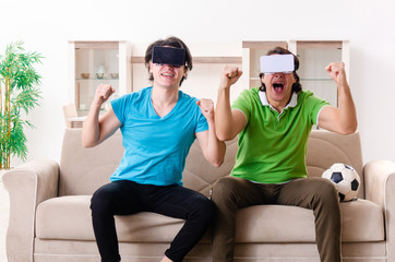 Friends watching football at home