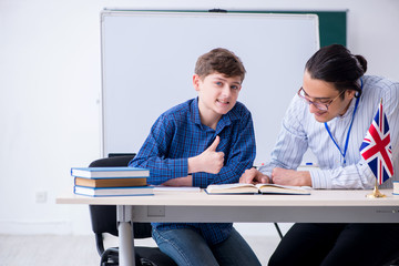 Male english teacher and boy in the classroom