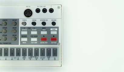 White analog synthesizer sampler with knobs and keys. Audio equipment for musical production. Drum machine. White background. Music concept.