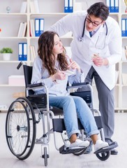 Obraz premium Disabled patient on wheelchair visiting doctor for regular check