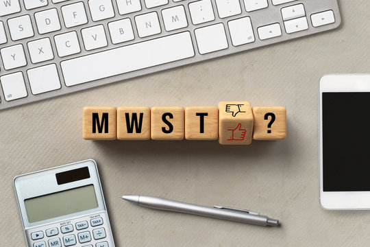 Würfel mit Smiley-Optionen auf die Frage "MwSt" für Mehrwertsteuer vor Computer Tastatur