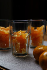 Preparing the tangerine in drinking glass to make a orange smoothy